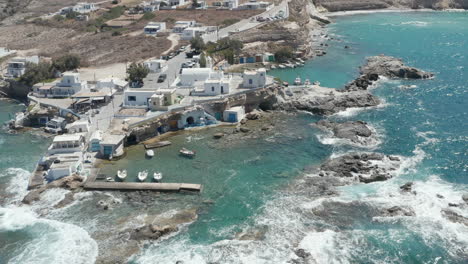 Wide-Establishing-Shot-of-Greek-Fishing-Village-build-right-by-the-Ocean-with-beautiful-Turquoise-Water