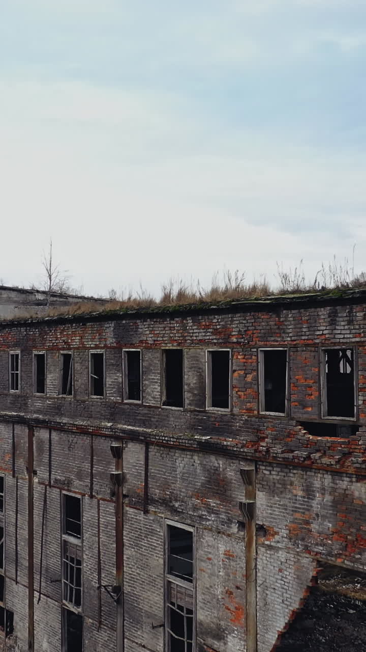Ruins of an old factory. Old industrial complex. Aerial view Vertical video