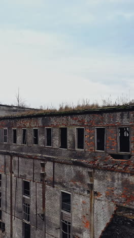 ruins of an old factory. old industrial complex. aerial view vertical video