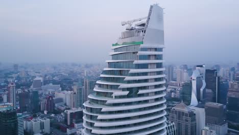 aerial view of a spiral skyscraper under construction in bangkok