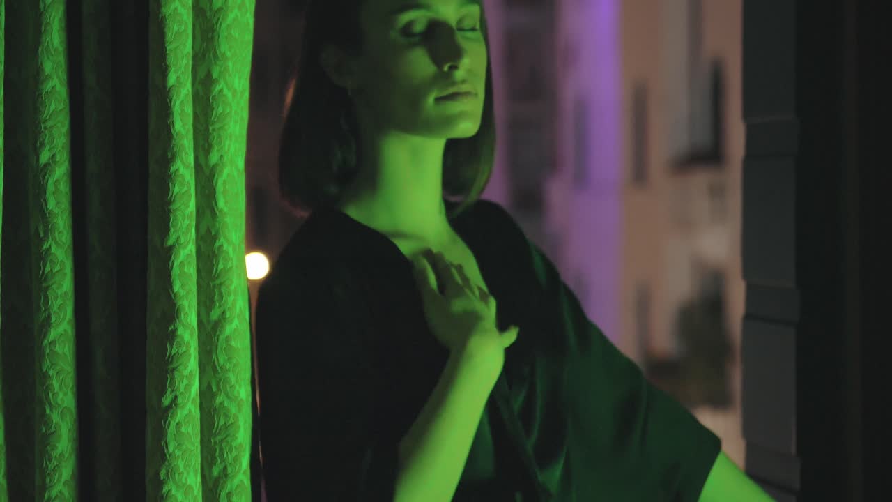 Sensual woman against apartment window