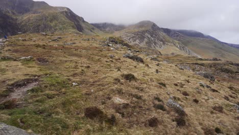 panning-over-Cwm-Idwal,-beautiful-landscape-in-Snowdonia-National-Park,-North-Wales-on-a-wet-windy-day