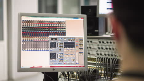 close-up view of computer screen displaying audio mixer or broadcast control software with detailed settings, professional studio or broadcast environment, control room technology