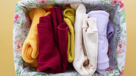 folded clothes in a floral basket