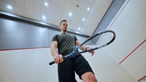 Low angle captures precise squash ball warm-up, indoor court scene, Slow motion