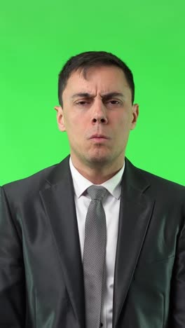 man in suit showing various expressions on green screen
