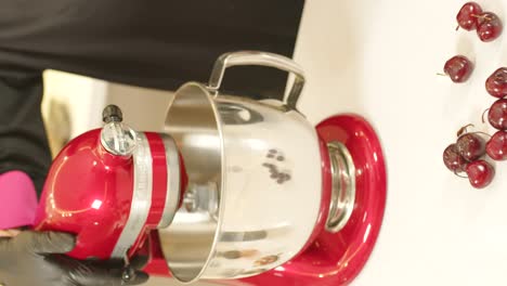 Kitchen-scene-with-mixer-working-and-cherries-on-table