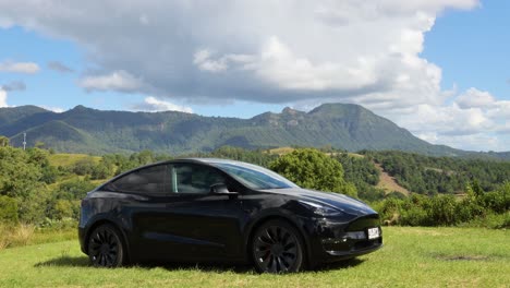 black car driving through picturesque mountain scenery