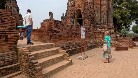 visitors walking around historic temple ruins