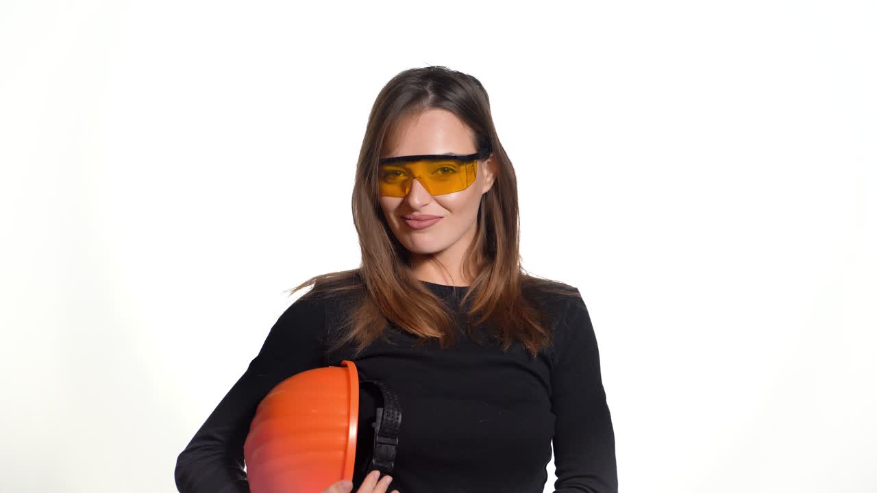 Female construction worker. Woman wearing protective helmet. Positive human emotions. Attractive young girl on white background.