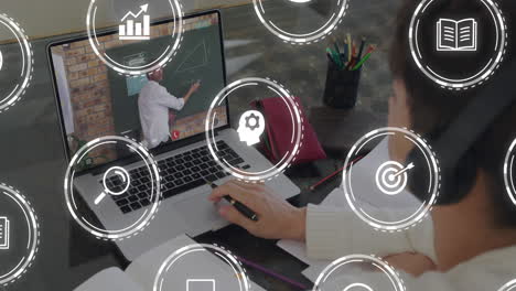 High-school student wearing headphones solving math on laptop, displaying floating e-learning icons