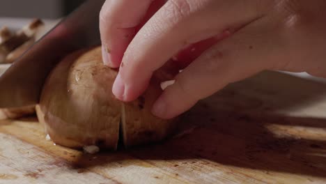 Hands-Cut-The-Mushrooms-On-A-Wooden-Cutting-Board---Macro-Shot