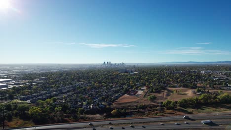 drone shot rising up over a highway outside of denver, co on a sunny fall day