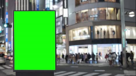 green screen billboard on a busy crossroad with traffic, neon lights, tokyo, japan