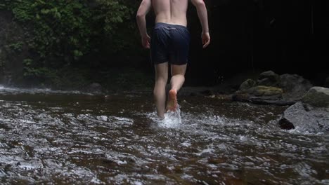 Man-Walking-Barefoot-in-a-Stream