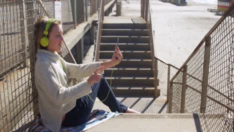 girl taking selfie with mobile phone near beach 4k