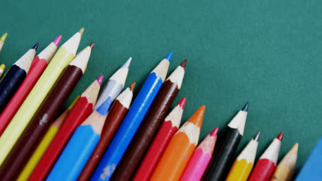 School-bag-icon-against-close-up-of-school-equipment-on-green-surface