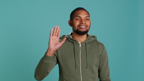 portrait of cheerful man smiling, waving hand