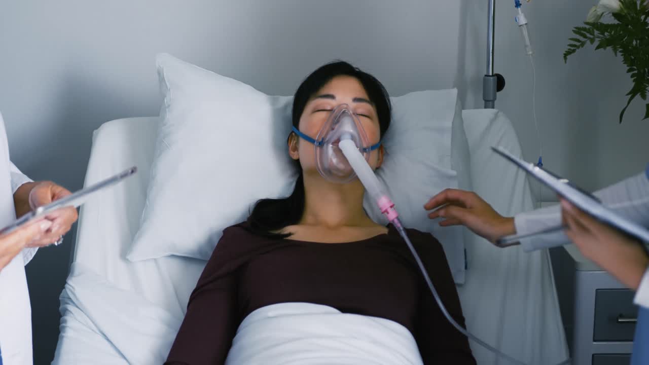 두 명의 의사가 병원 침대 4k에 여성 환자를 돌보고 있습니다.