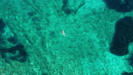 Lone-Person-Swims-On-A-Turquoise-Color-Water-Of-Adriatic-Sea-By-The-Island-Of-Losinj-During-Summer-In-Kvarner-Gulf,-Croatia