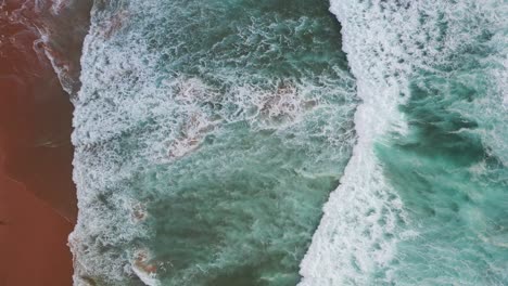 praia do tonel portugal splashing strong ocean waves, aerial top view shot