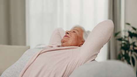 Smile,-relax-and-senior-woman-stretching-on-sofa