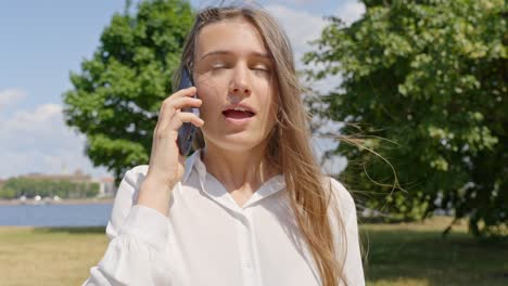 Woman-making-faces-while-calling,-discussing-using-smartphone