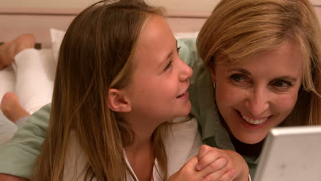 Happy-mother-and-daughter-using-laptop