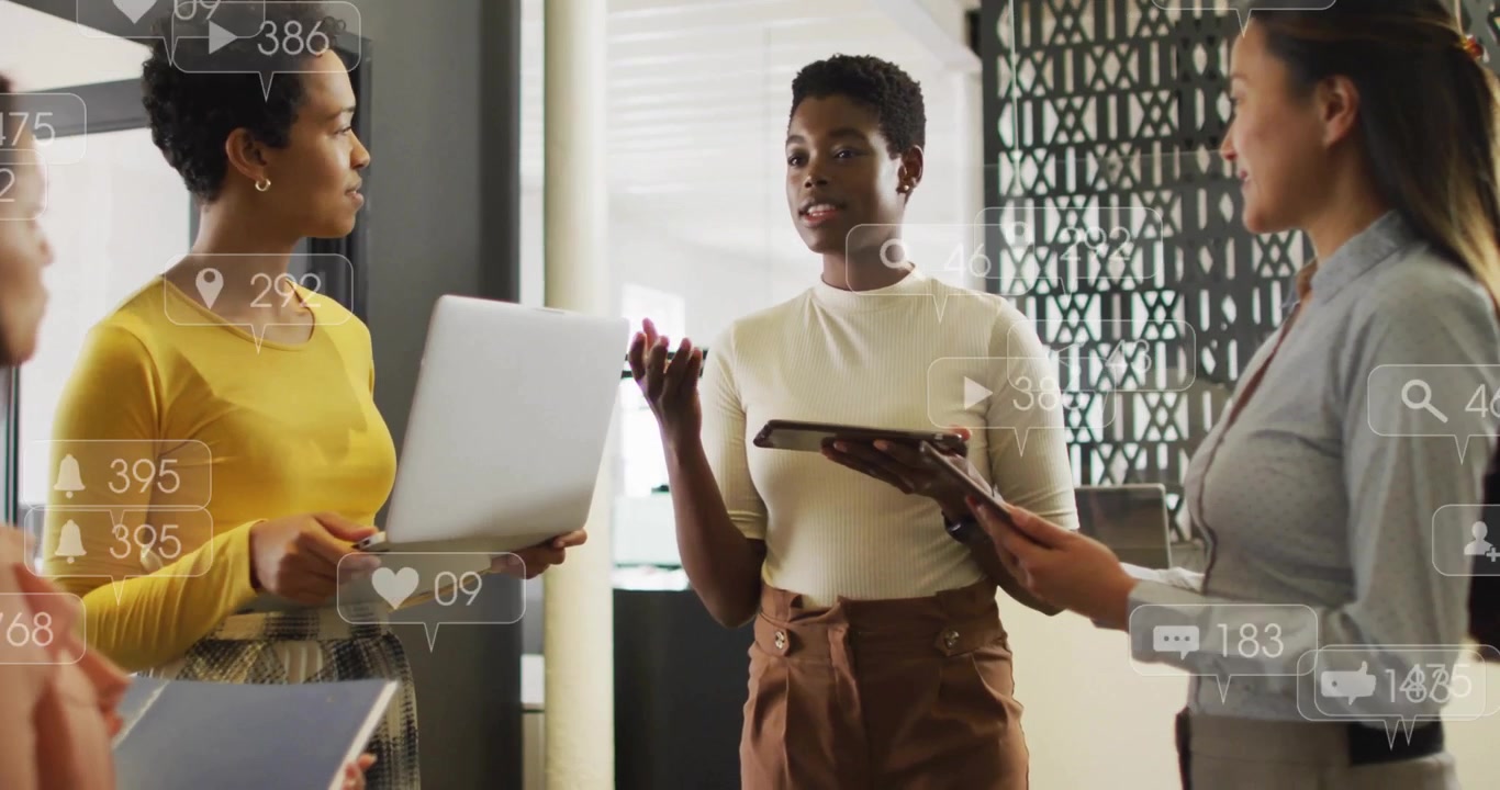 Three marketers referencing devices and analyzing dynamic social media metrics floating around them