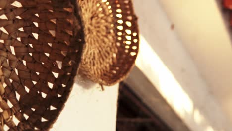 wicker and straw baskets hanging on a wall