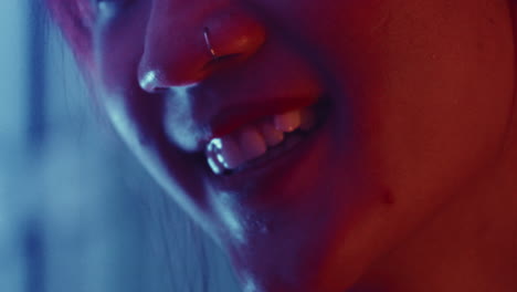 portrait close up of asiatic sexy woman in soft red light gently moving her head while smiling