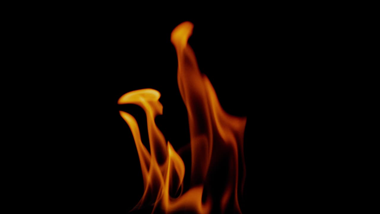 Slow motion fire flame, super slow hot power of bon fire on dark night background, red orange flame glowing and blazing