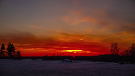 golden sunset over a snowy countryside landscape - time lapse