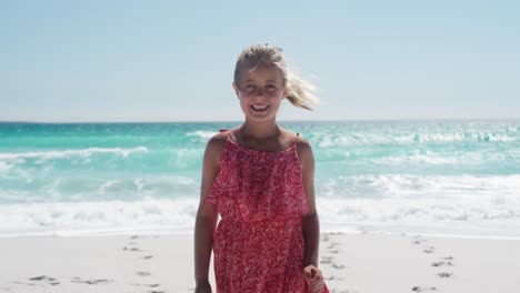 Girl-standing-on-the-beach-and-looking-at-camera