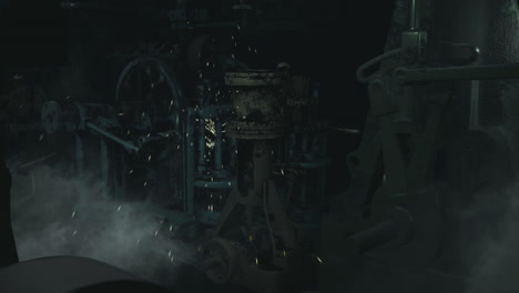 old industrial machinery surrounded by smoke in a dimly lit space