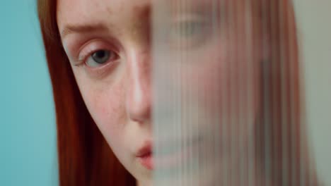 close-up portrait of a woman behind a translucent material