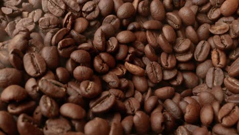 close up of seeds of coffee. fragrant coffee beans are roasted smoke comes from coffee beans.