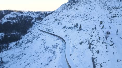 drone video of abandoned donnner pass california railroad tunnels on mountain pass covered in snow