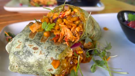 delicious healthy chicken wrap with vegetables in marbella spain, brunch at a restaurant, 4k shot