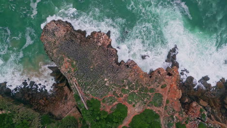 stormy sea water breaking rough coastal cliffs top view. ocean waves