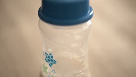 extreme close up of a baby bottle with milk