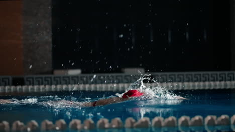 a swimmer competes in a pool