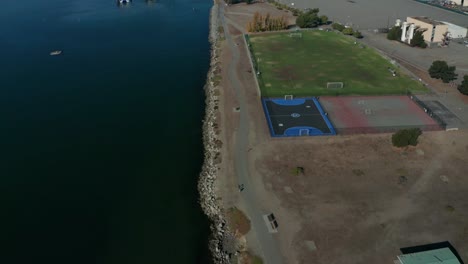 a long push forward over the shore line in the urban city built by the bay.