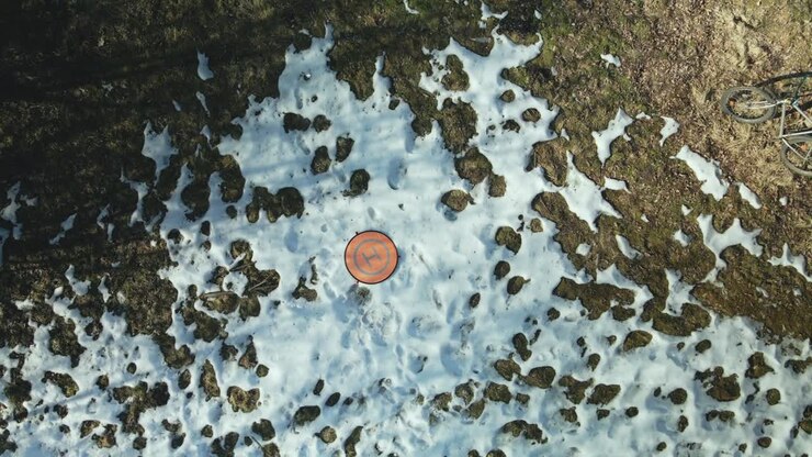 Drone landing on site. Landing mat on a wasteland. Aerial photography.