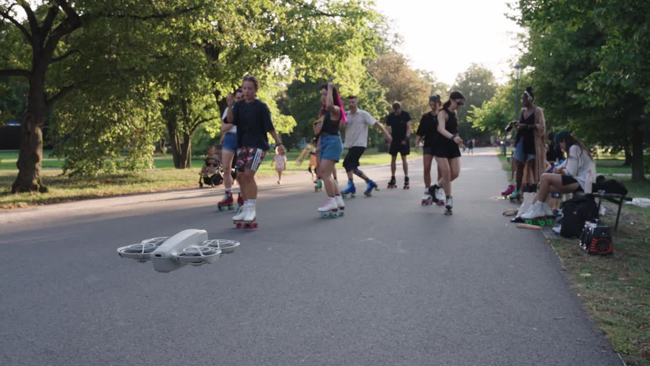 Group of People Roller Skating in a Park with a Drone Flying Above