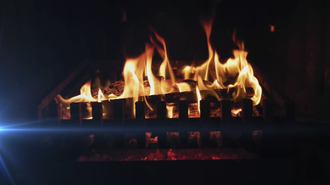 Flickering yellow flames sparking logs growing upward settling ember glow keeping hearth warm