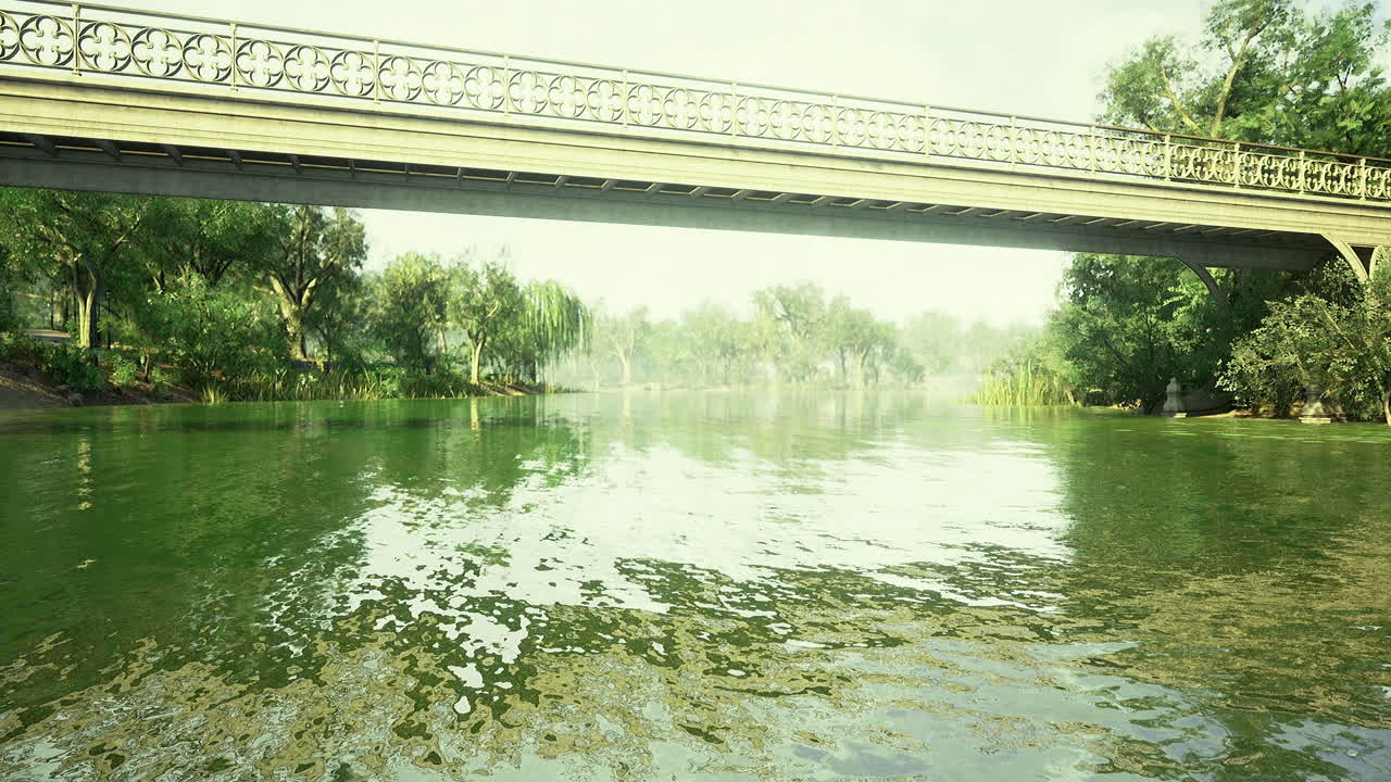 View of a serene river flowing beneath a decorative bridge in a lush landscape