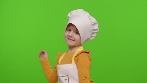 niña divertida niña niño vestido cocinero cocinero panadero en delantal y sombrero bailando, tonto, haciendo caras