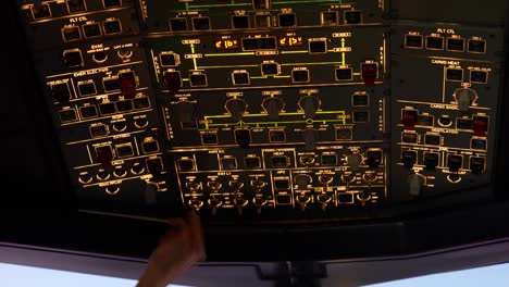 Airbus A320 cockpit toggle controls button interior, pilot making adjustment mid flight