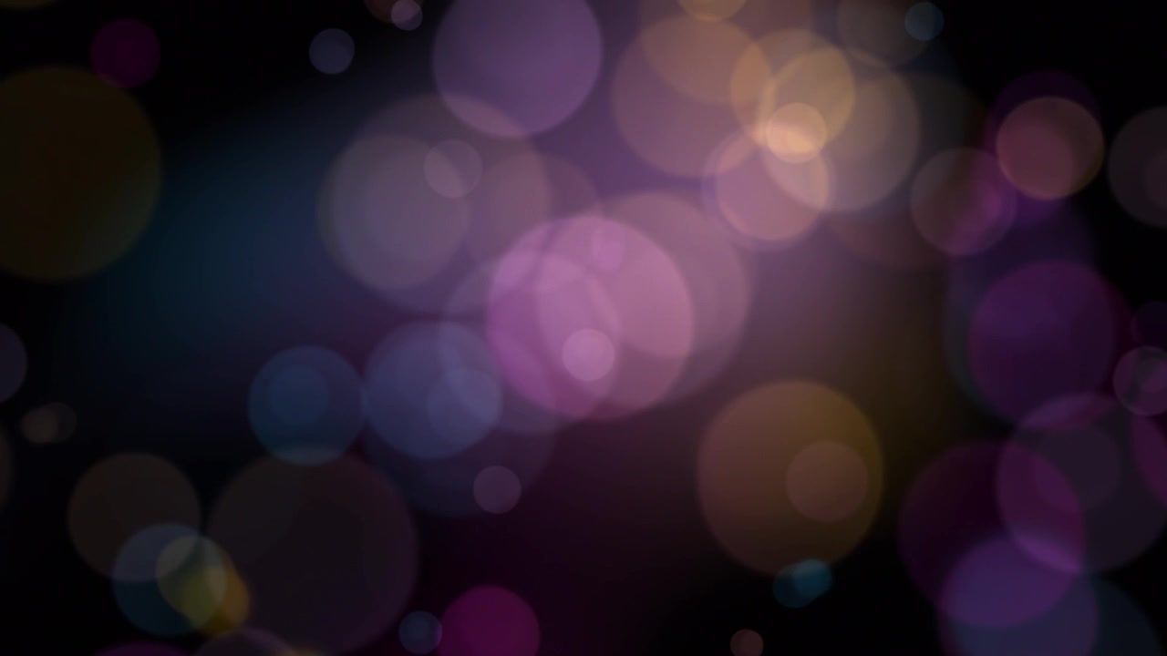 Luci bokeh astratte e colorate in movimento su uno sfondo scuro